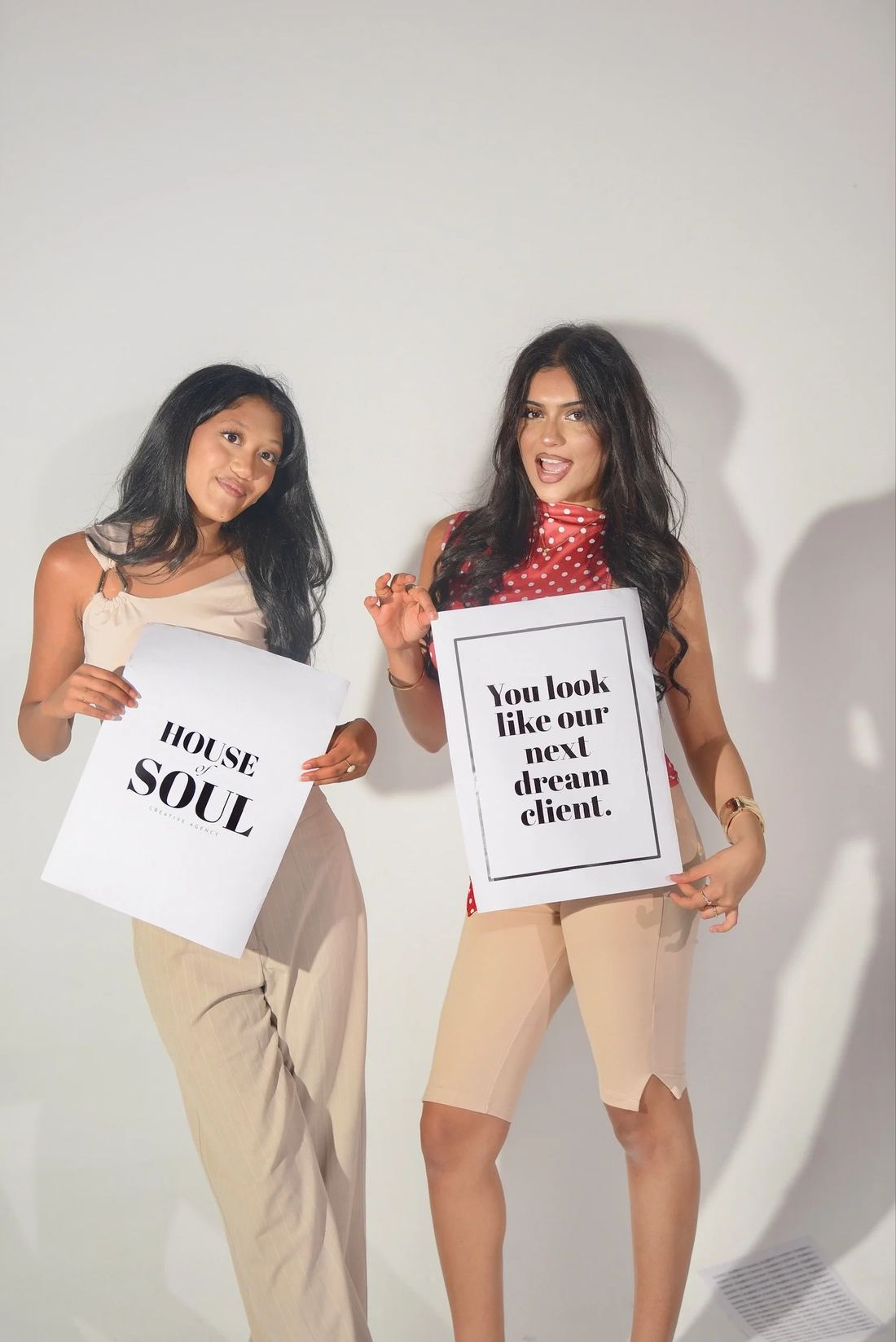 Jannat Javaid and Elisha Sugano holding House of Soul prints in the studio