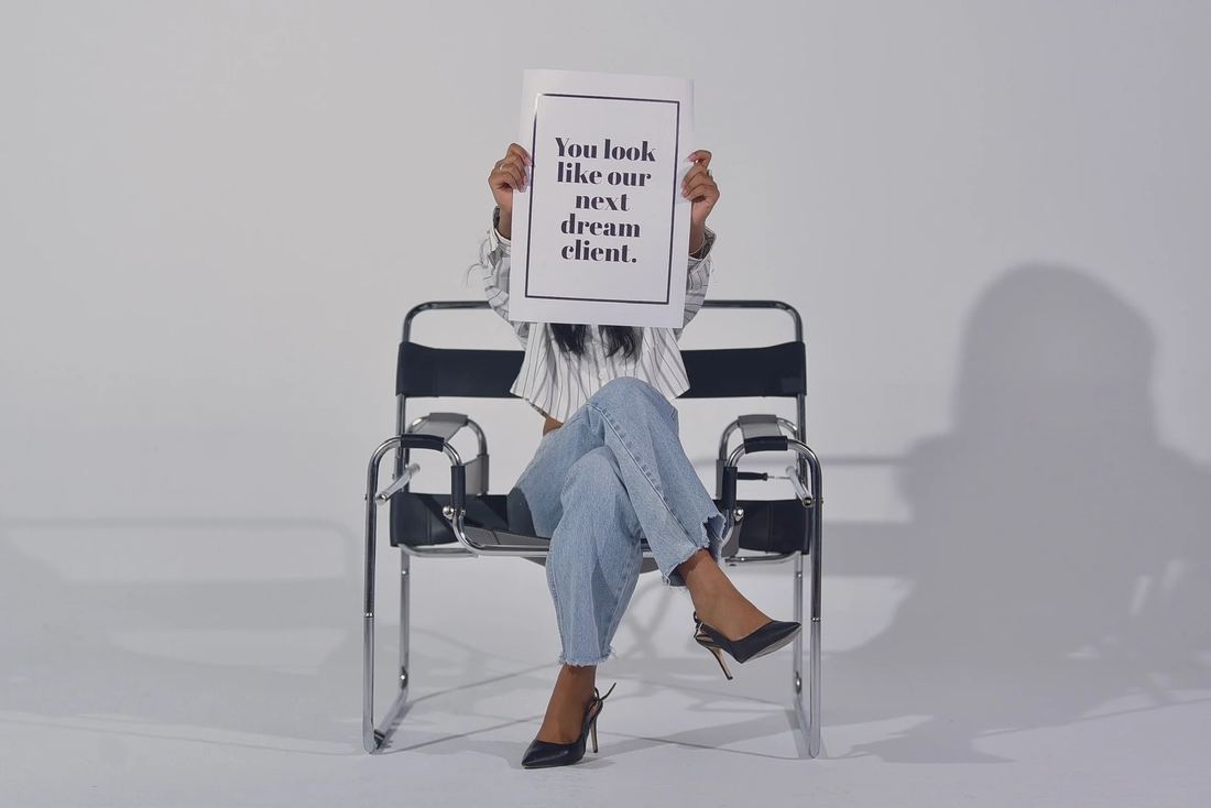 A House of Soul founder holding a printed card that reads: you look like our next dream client