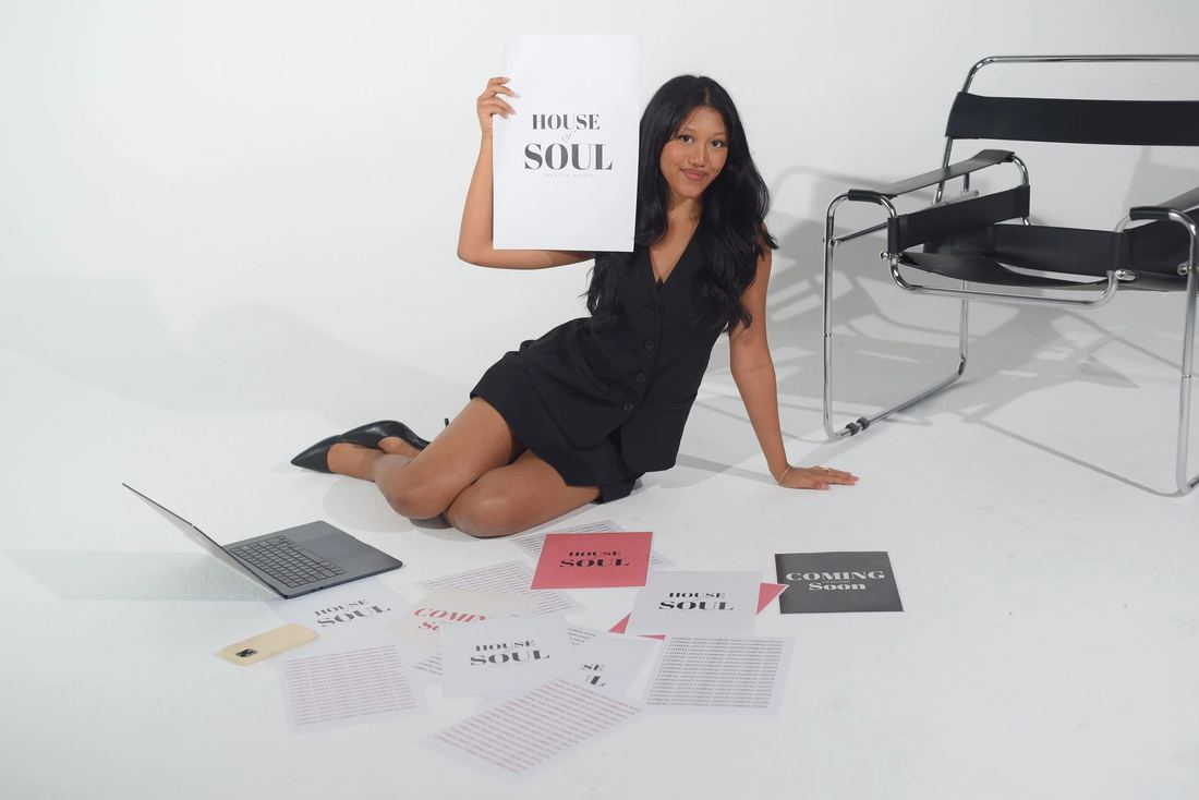 A founder holding a House of Soul poster among printed launch collateral